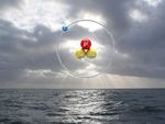 Symbolbild für Tritium im Meer: Ein Tritium-Atom vor einem Meeresbild. 