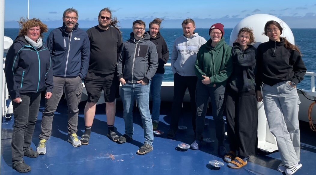 The scientific participants on the windy observation deck. Group photo of the nine participating scientists on the Tarajoq's observation deck.