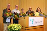 The award-winning authors with bouquets of flowers
