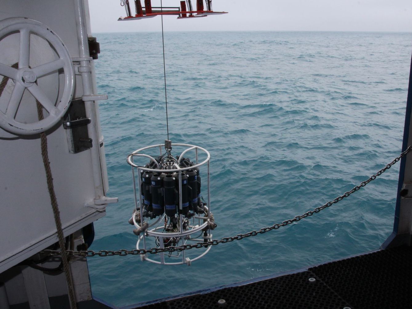 A CTD for measuring salinity, temperature and fluorescence is released into the water.