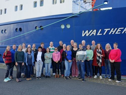 Workshop participants in front of our research vessel.