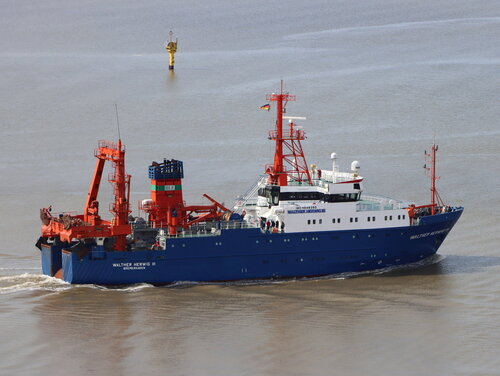 The Walther Herwig III fisheries research vessel in the Outer Weser off Bremerhaven The ship photographed from the side. It is painted blue (hull), orange (superstructure), and white (bridge).