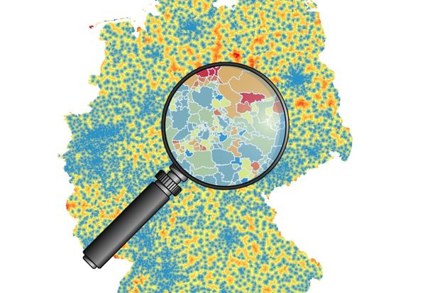 A color map of Germany with one part magnified with a magnifying glass.